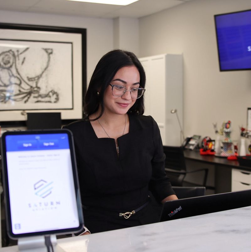 Woman at desk of Saturn Aviation helping with trip support