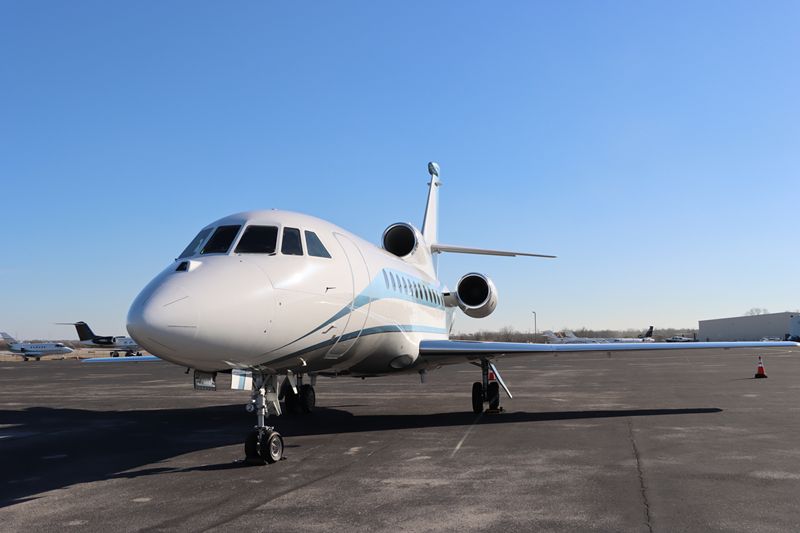 Blue and white charter jet on runway
