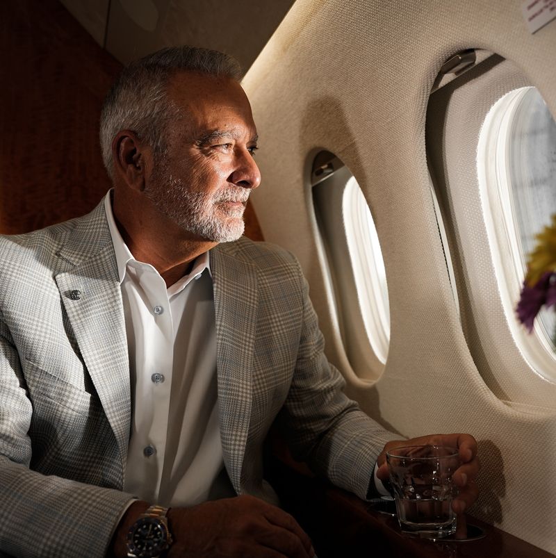 Man looking out the window of a jet