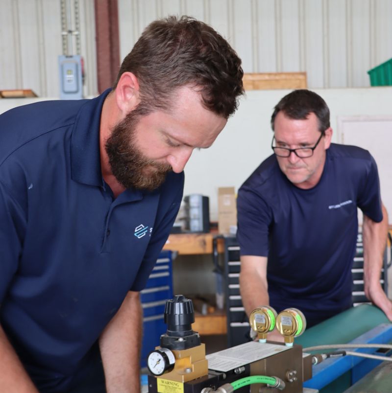 Aircraft workers in blue shirts
